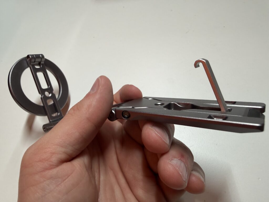 Ich halte das Stativ in der Hand und habe den Haken ausgeklappt.